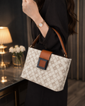 Beige monogram bucket bag worn on shoulder lifestyle shot