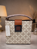 Beige monogram bucket bag front view with tag