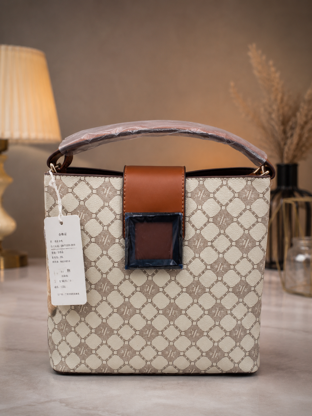 Beige monogram bucket bag front view with tag