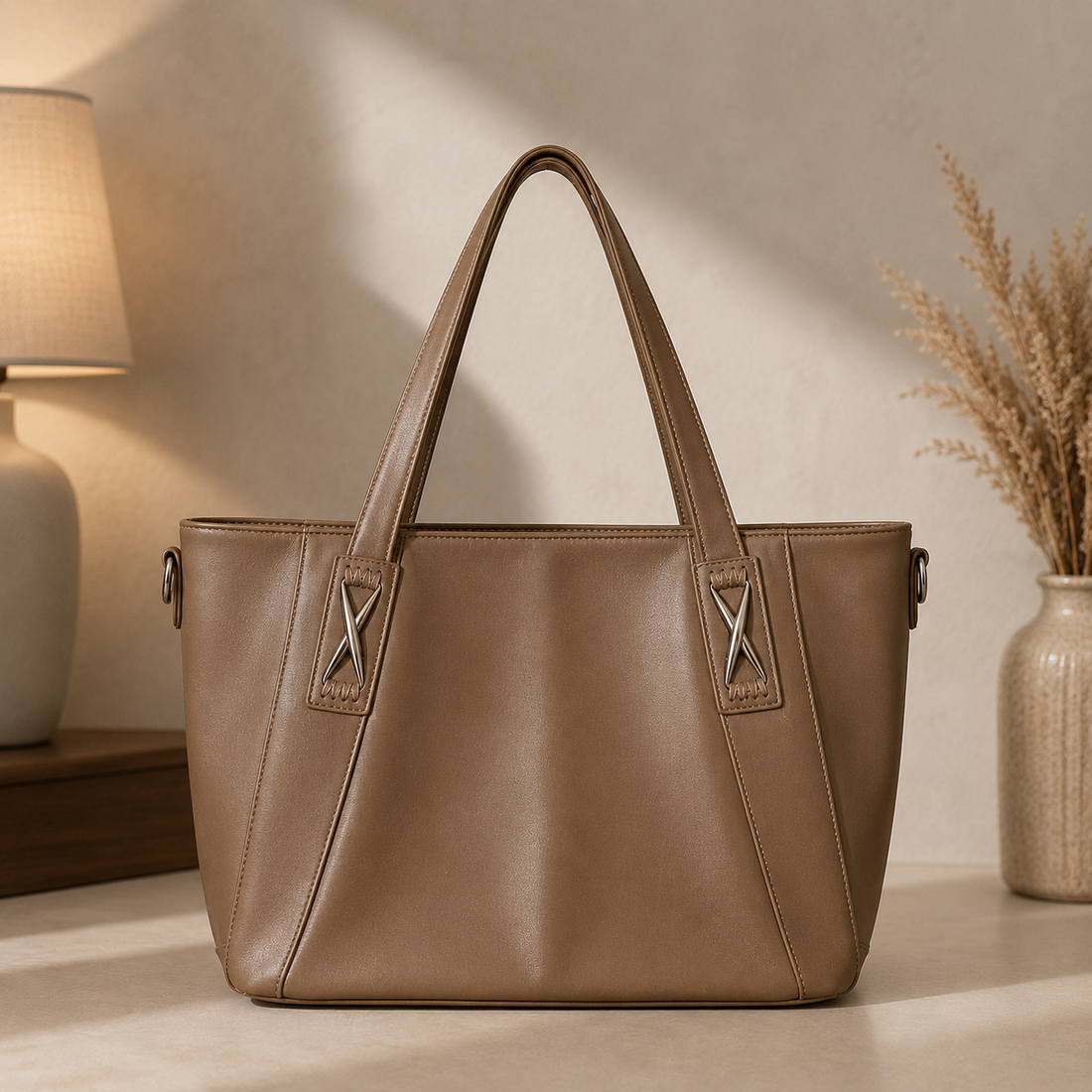 Mocha leather mega tote bag hanging on rack